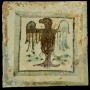 Carreau de pavement à décor vert et brun d'aigle, début XIVe siècle, découvert lors des fouilles de Sainte-Barbe. Collection musée d'Histoire de Marseille. 